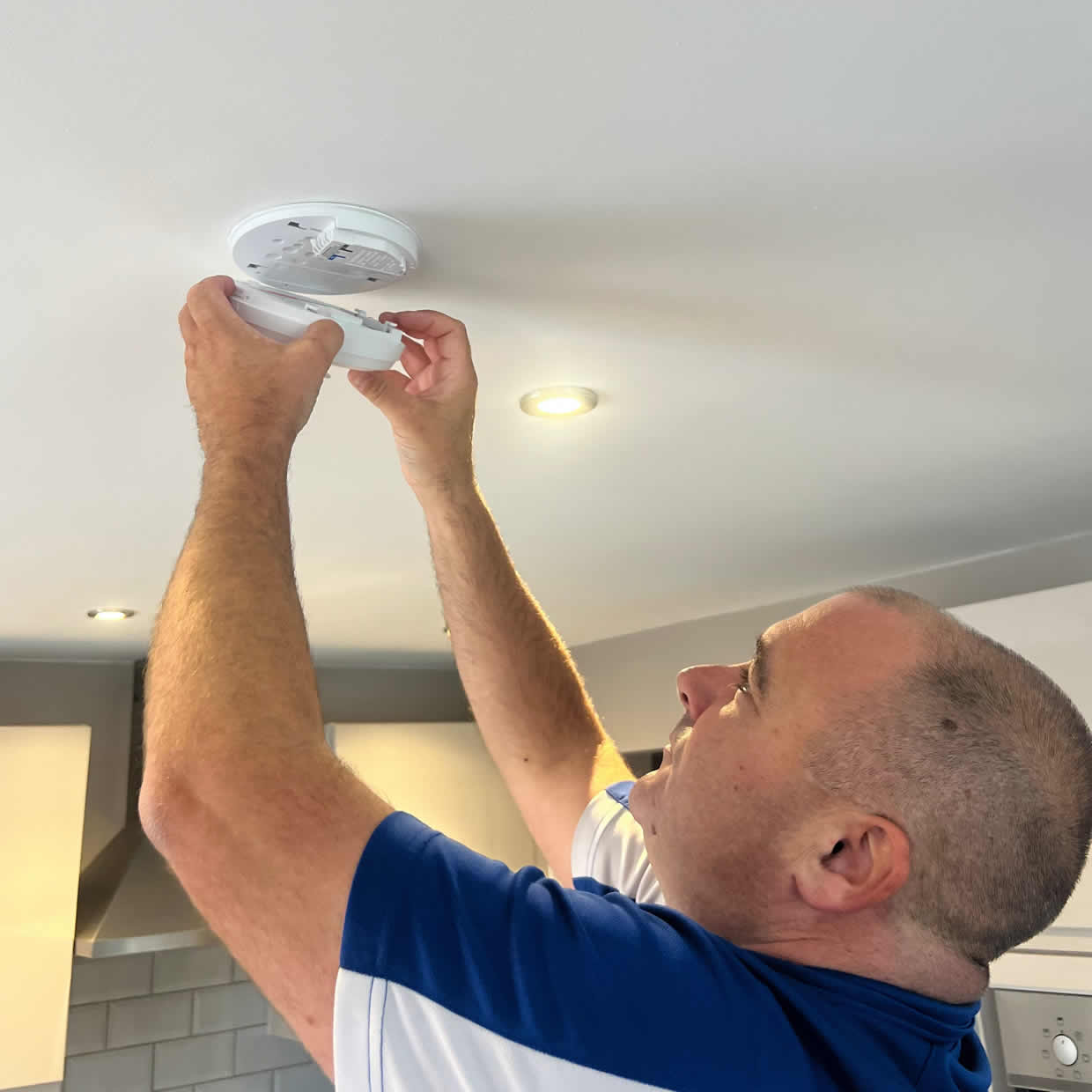 Smoke alarm being installed on a ceiling in Barking